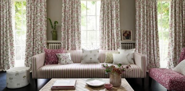 Country cottage style living room with stripey couch and floral curtains