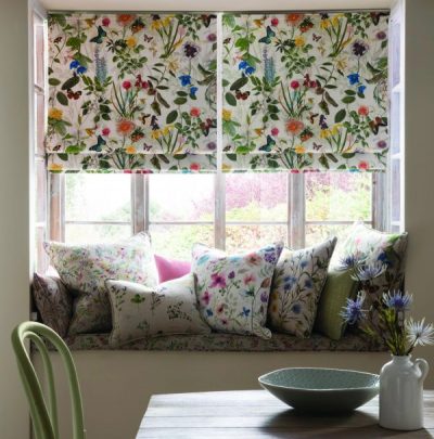 window seat with cushions and colourful blinds